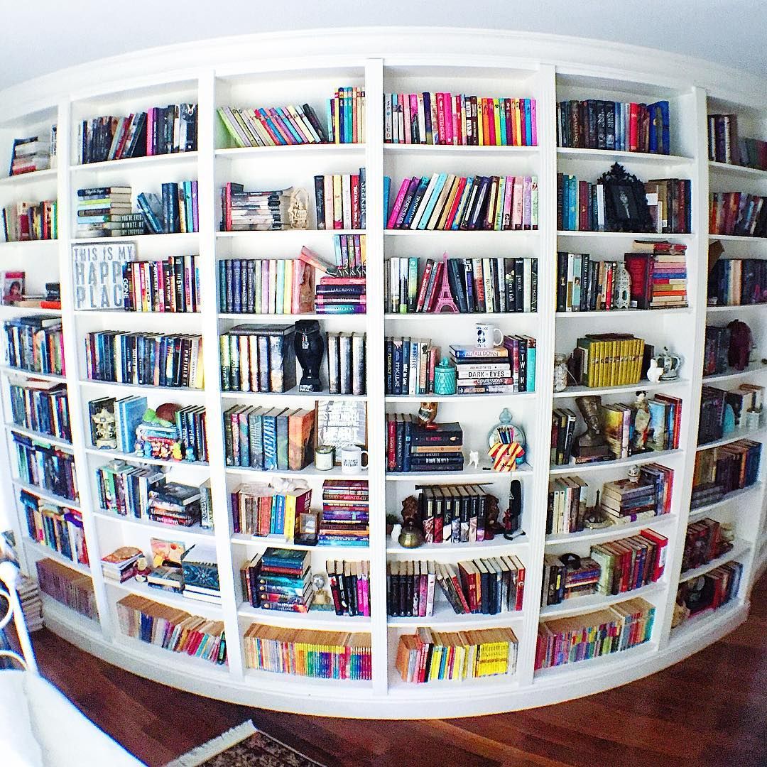 BOOKS BEING SHELVED IN SHELVES IN ROUNDED SHELVES.